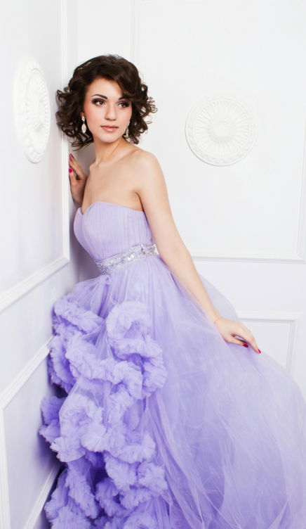 woman in purple strapless wedding dress leaning on wall